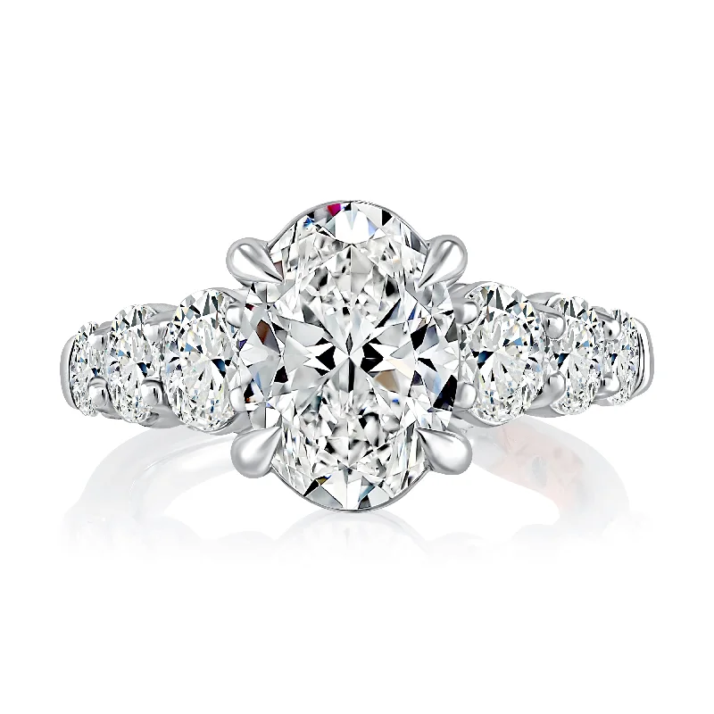 women's engagement rings pear cut -Classic Four Prong Oval Cut Diamond Flanked Engagement Ring